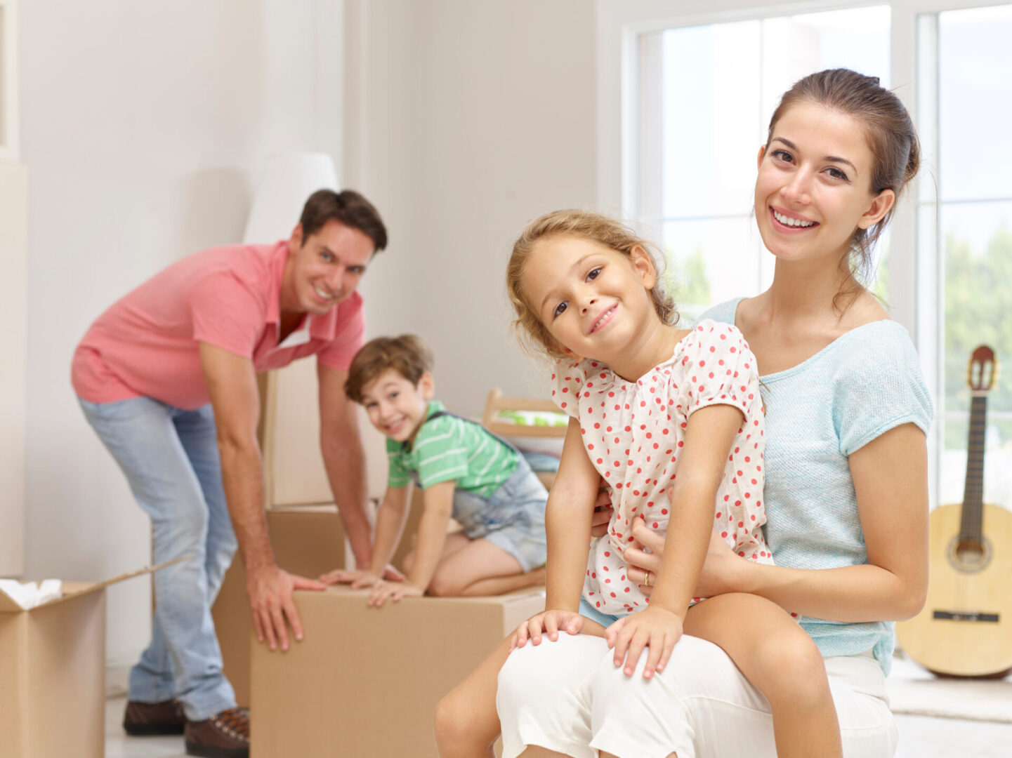 Family unpacking boxes in new home.