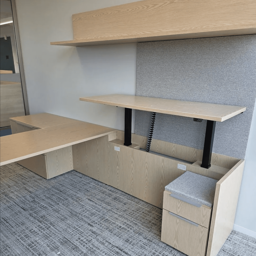 Modern office setup with a desk, drawers, and shelves in a neutral tone.